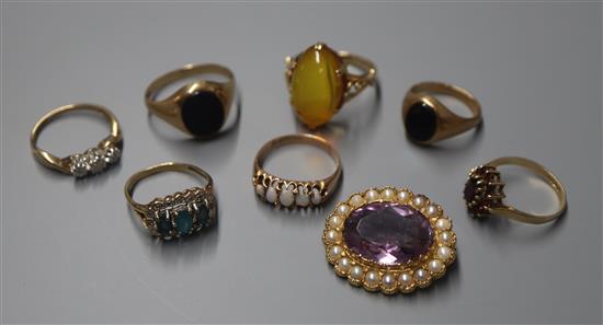 Seven assorted 9ct and gem set rings including five stone opal and a 9ct gem set brooch.